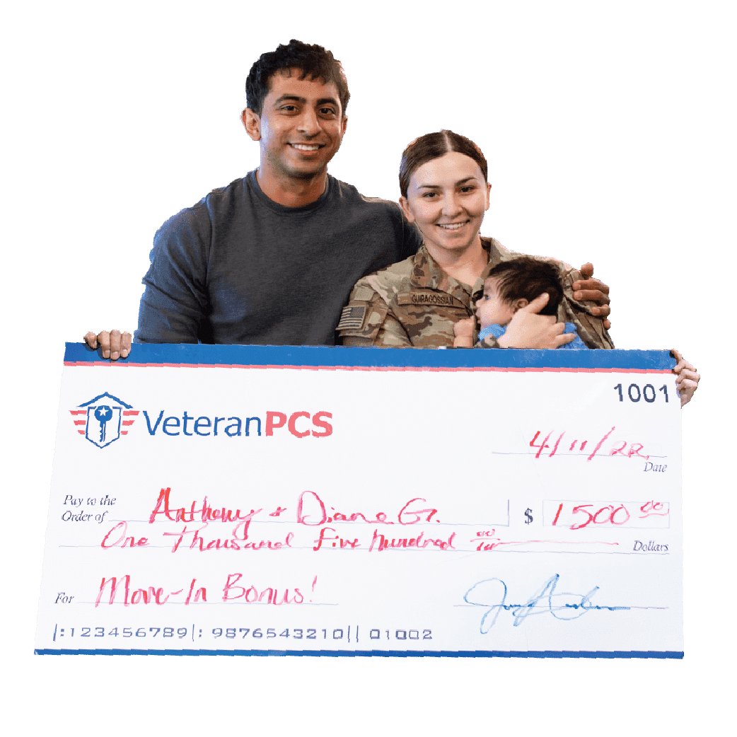 A military couple stands in front of their newly purchased home after using a military-friendly realtor from VeteranPCS