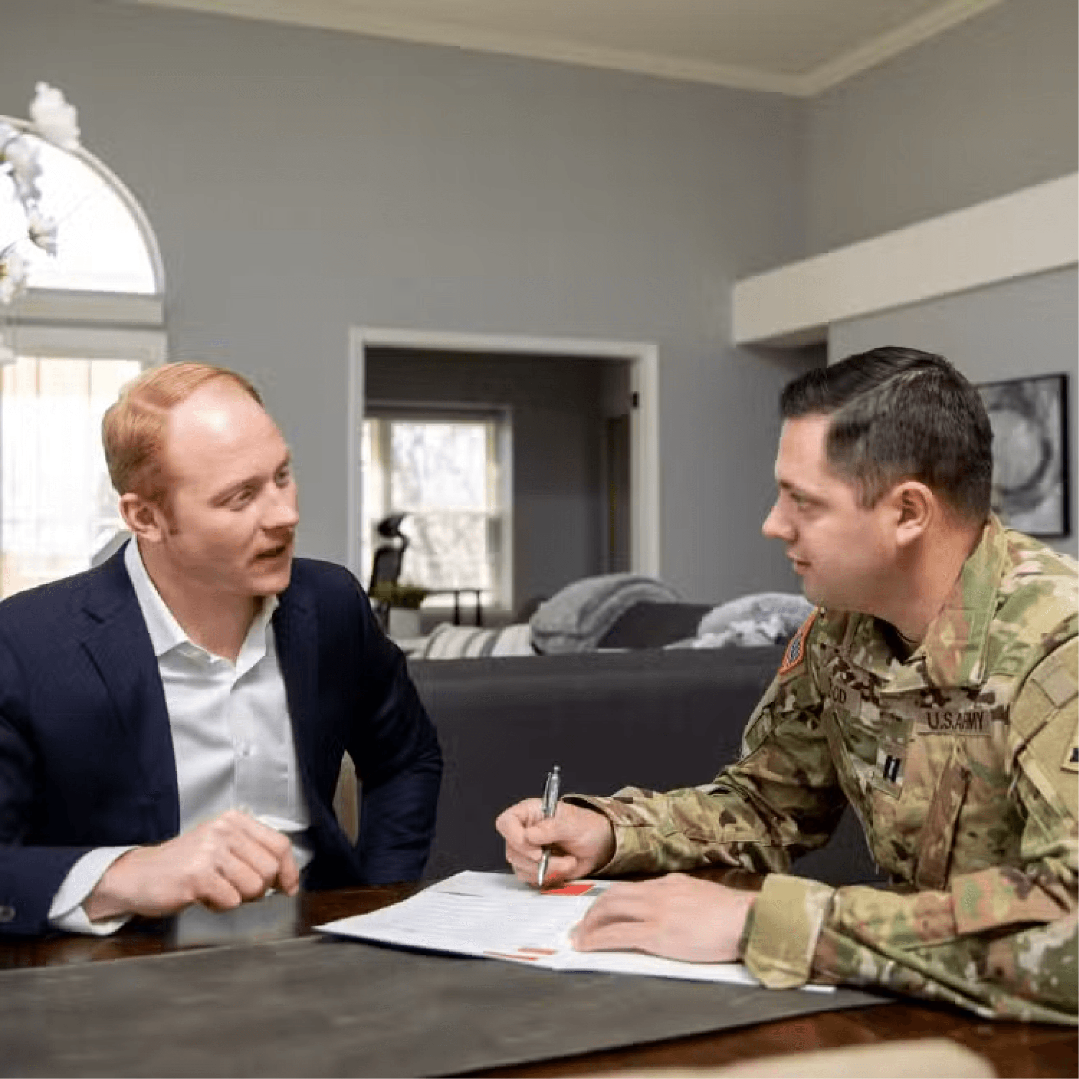 Real estate agent reviewing paperwork with a service member