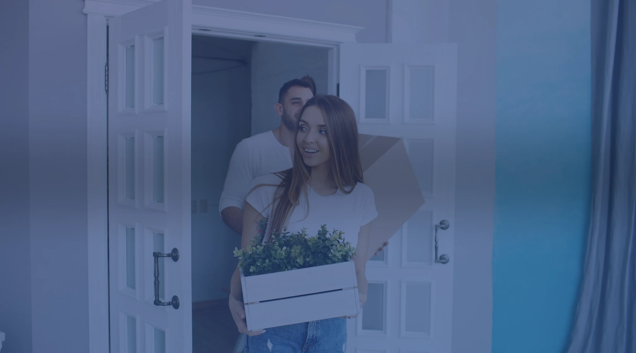 Military family carrying boxes into a new home during a PCS move