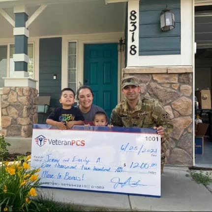 VeteranPCS military family holding their move-in bonus check