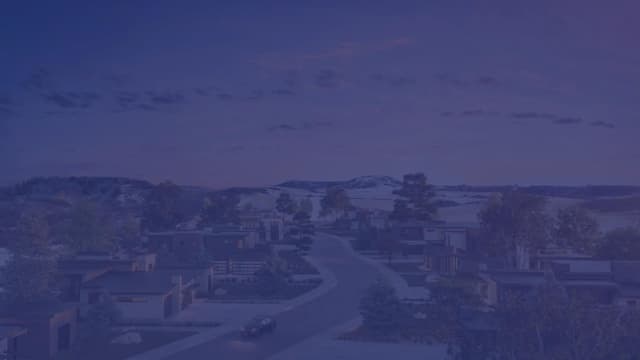 A sweeping view of the Crystal Valley community at sunset, showcasing the ridge line and distant mountains.