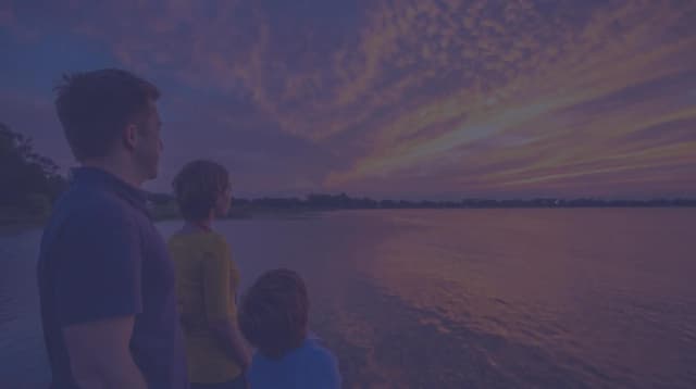 A family of three looks at the coast of Florida.